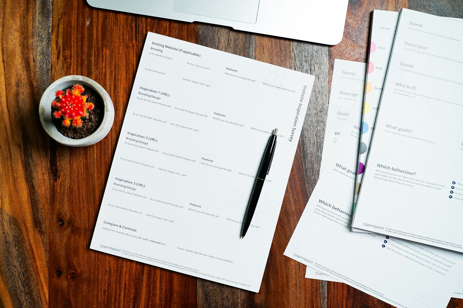 Paperwork and a pen on a wood desk