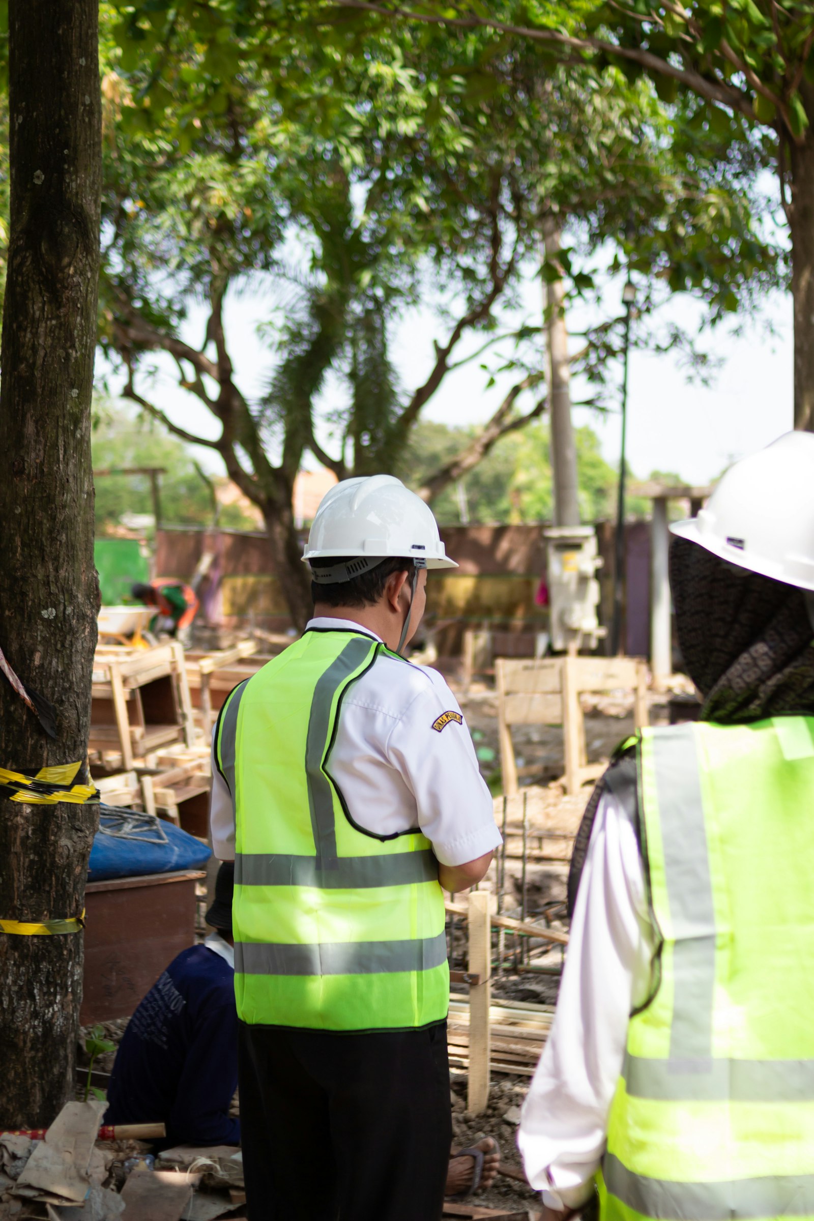 Construction workers in safety vests at a building site